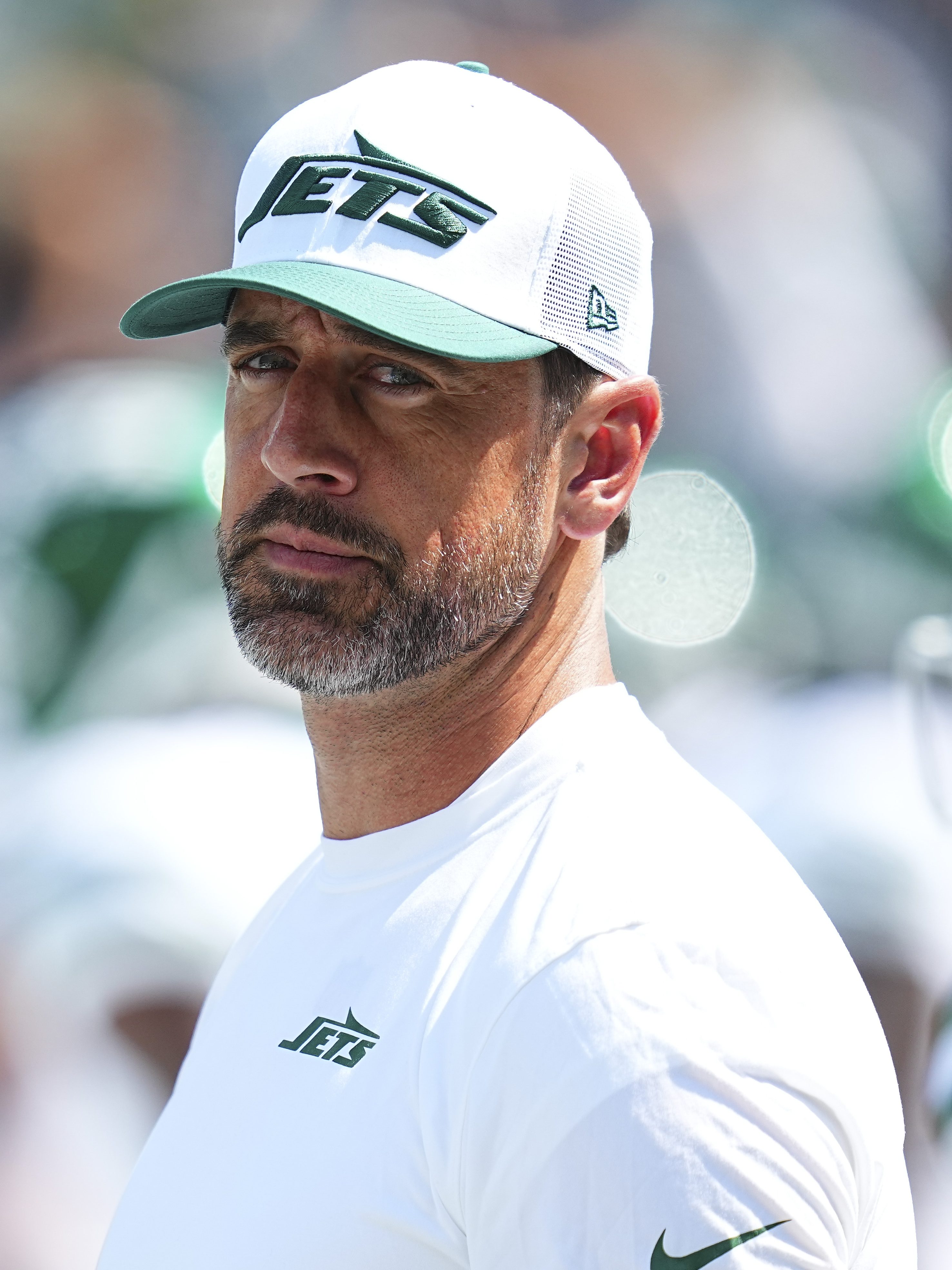EAST RUTHERFORD, NEW JERSEY - AUGUST 10: Aaron Rodgers #8 of the New York Jets looks on against the Washington Commanders during the preseason game at MetLife Stadium on August 10, 2024 in East Rutherford, New Jersey. The Jets defeated the Commanders 20-17. (Photo by Mitchell Leff/Getty Images)