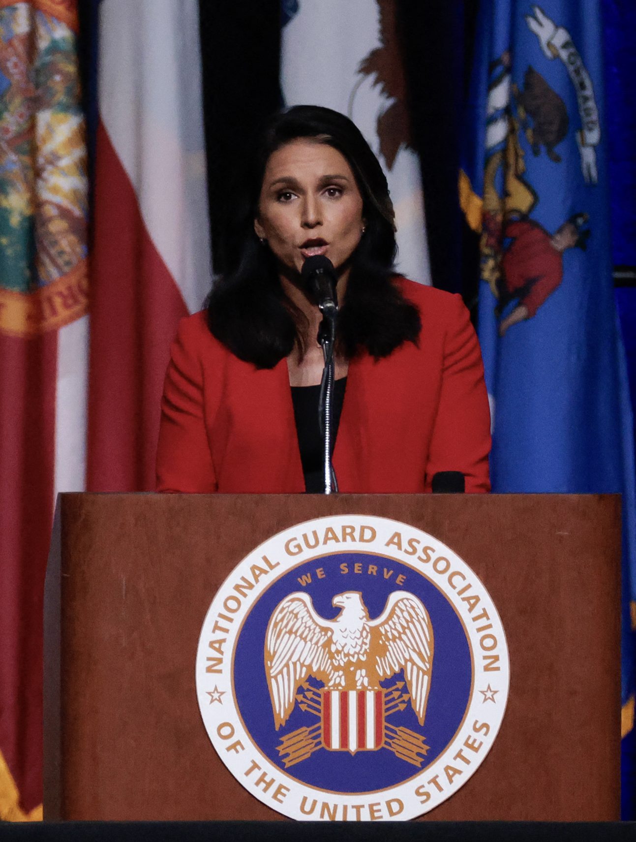 Donald Trump looks on as former US Representative Tulsi Gabbard endorses him