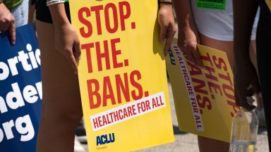 ATLANTA, GA - JULY 23: A protester holds a sign while marching and chanting through Downtown Atlanta, in opposition to Georgia's new abortion law on July 23, 2022 in Atlanta, Georgia. A federal appeals court has decided to allow a Georgia law that bans abortion after six weeks of pregnancy to go into effect.  Previously Georgia law allowed abortions up to 20 weeks of pregnancy.  (Photo by Megan Varner/Getty Images)