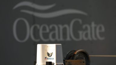 A decal on a piece of equipment that reads "Titan" pictured near a trailer with the OceanGate logo at the OceanGate Expedition headquarters at the Port of Everett Boat Yard in Everett, Washington, on June 22, 2023. The five people aboard the submarine that went missing near the Titanic wreck died -- possibly instantly -- after the boat hit a which the US Coast Guard said on June 22, 2023 is a "catastrophic implosion" in the depths of the ocean. (Photo by Jason Redmond/AFP) (Photo by JASON REDMOND/AFP via Getty Images)