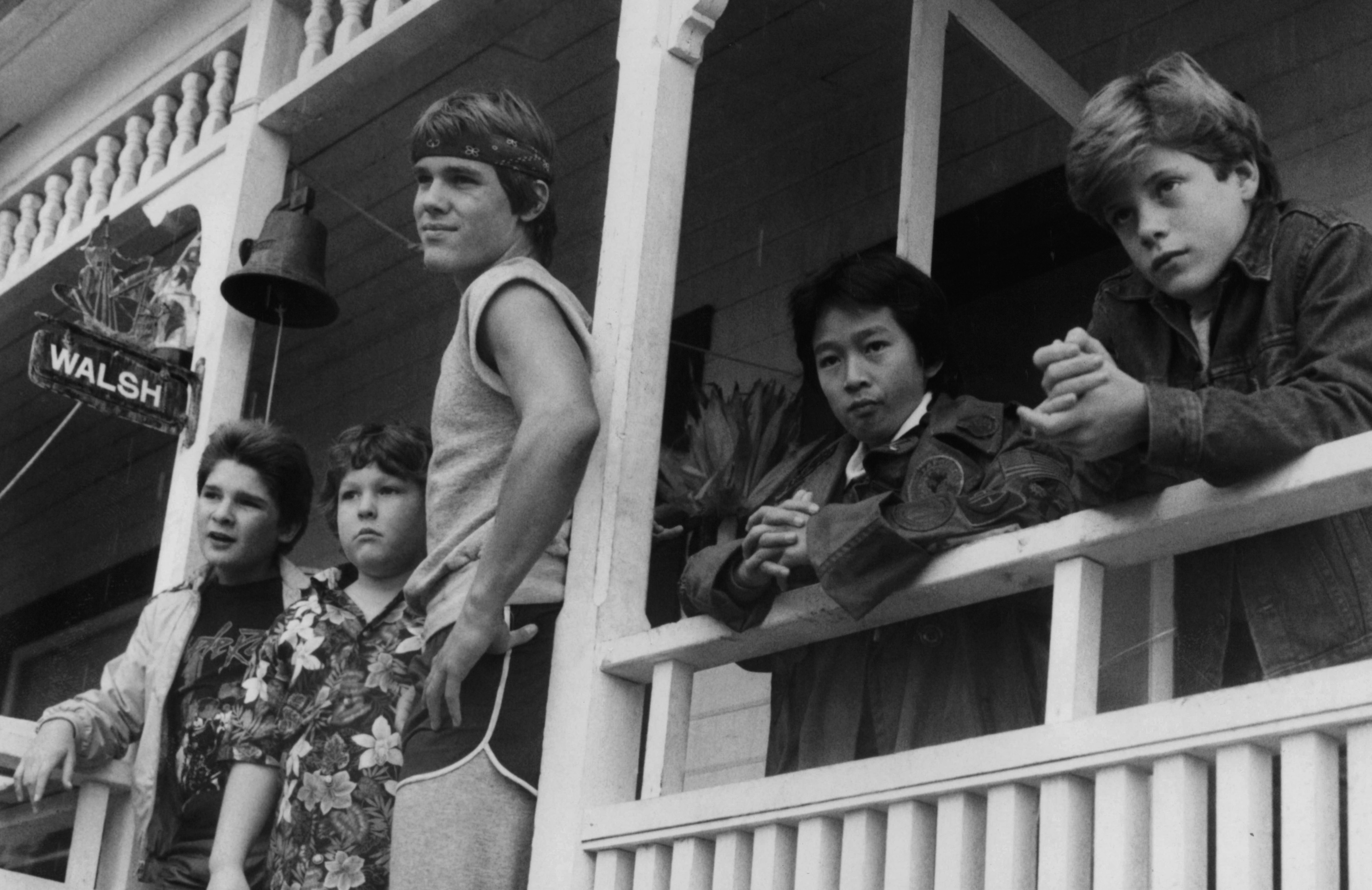 Corey Feldman, Jeff Cohen, Josh Brolin, Ke Huy Quand and Sean Astin standing on porch in a scene from 'Goonies'