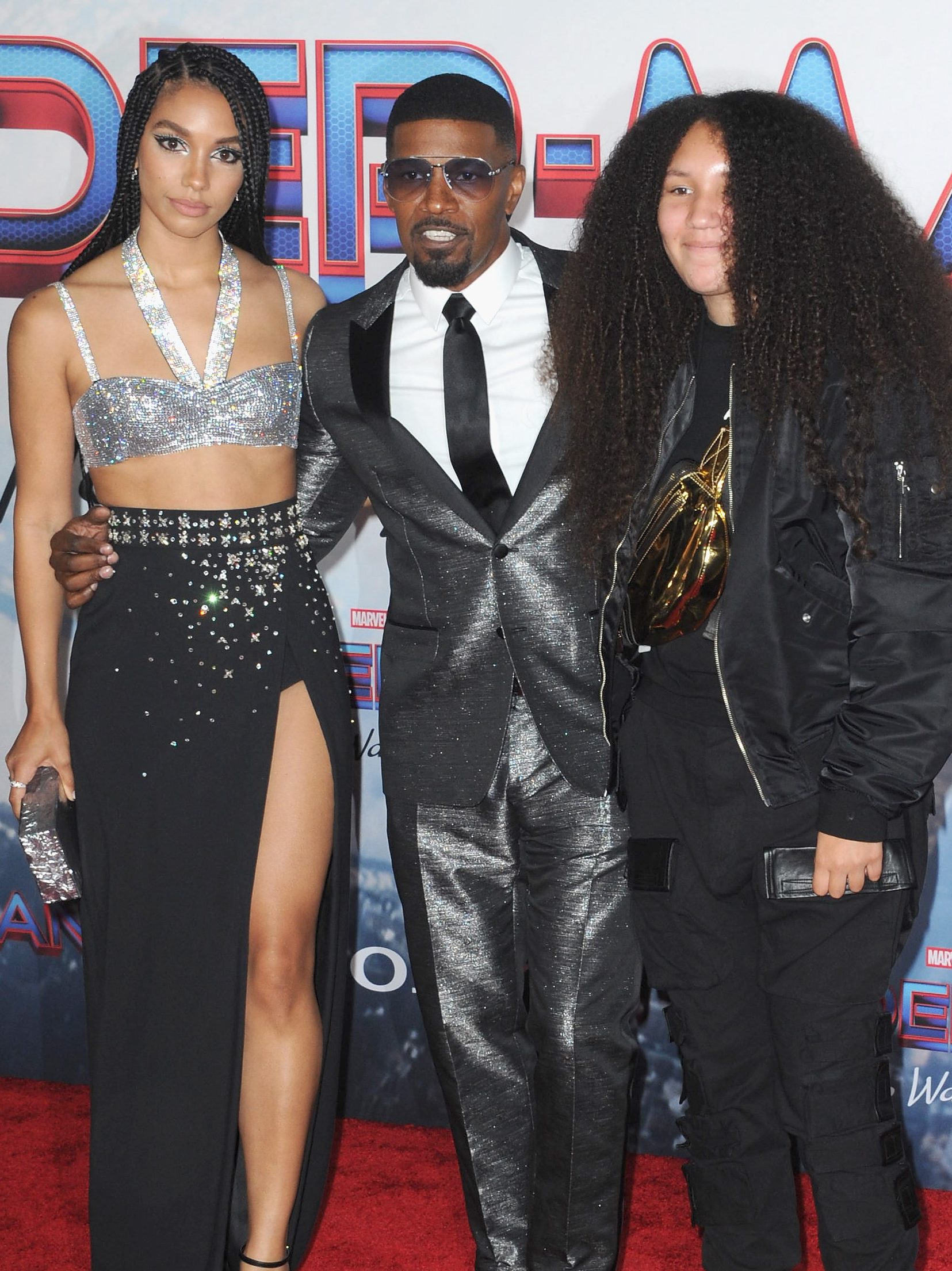 LOS ANGELES, CA - DECEMBER 13:   Corinne Foxx, Jamie Foxx and Annalise Foxx attend Sony Pictures' "Spider-Man: No Way Home" Los Angeles Premiere held at The Regency Village Theatre on December 13, 2021 in Los Angeles, California.  (Photo by Albert L. Ortega/Getty Images)
