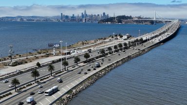  In an aerial view, traffic moves on the San Francisco-Oakland Bay Bridge on August 24, 2022 in Oakland, California. California is set to implement a plan to prohibit the sale of new gasoline-powered cars in the state by 2035 in an effort to fight climate change by transitioning to electric vehicles. (Photo by Justin Sullivan/Getty Images)