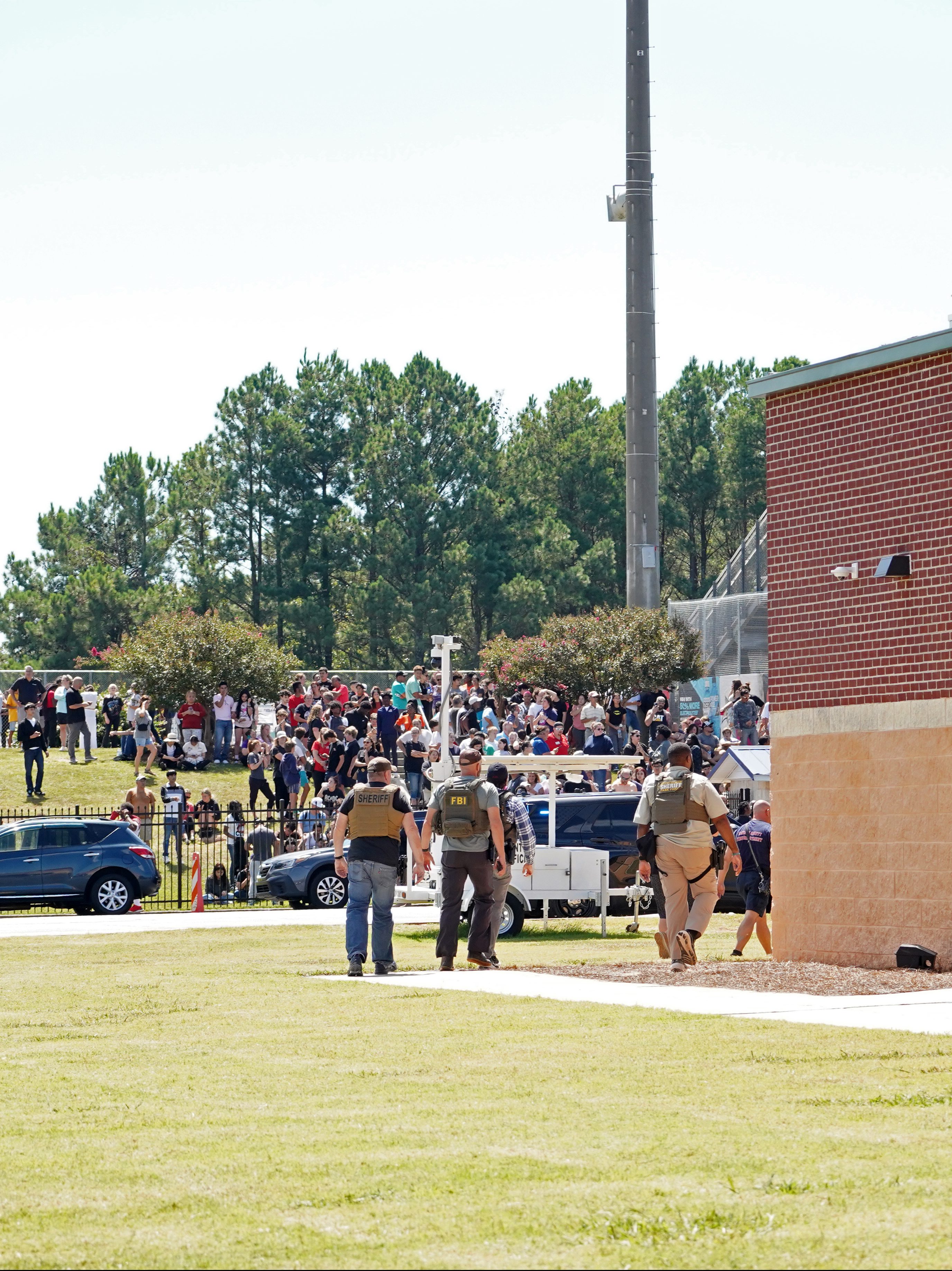 WINDER, GEORGIA - SEPTEMBER 4: Students wait to be picked up by their parents after a shooting at Apalachee High School on September 4, 2024 in Winder, Georgia. Multiple fatalities and injuries have been reported and a suspect is in custody according to authorities. (Photo by Megan Varner/Getty Images)