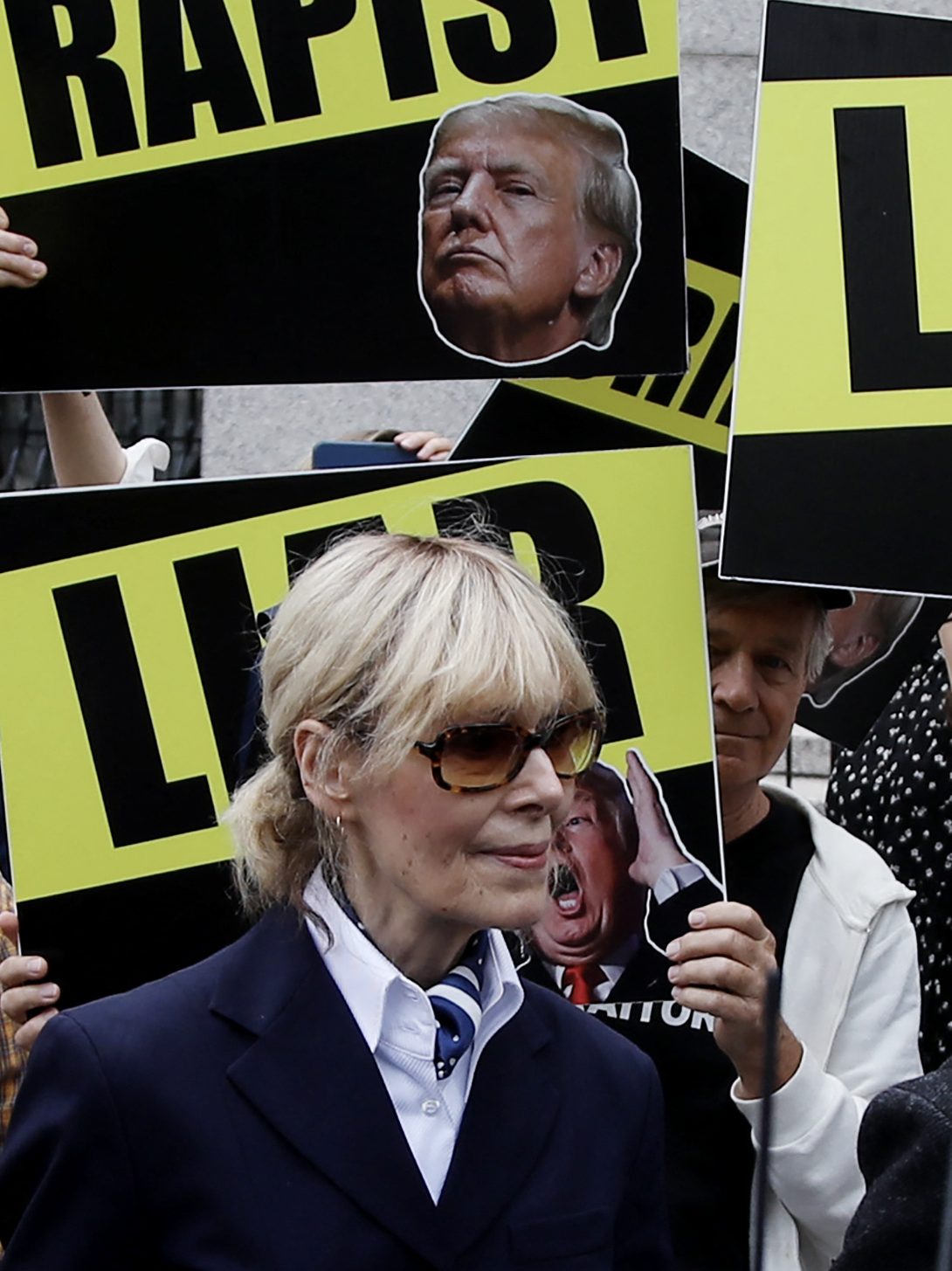 E. Jean Carroll (C) departs Manhattan federal appeals court following arguments in a judgement appeal brought by former US President Donald Trump, in New York City, September 6, 2024. Former US President Donald Trump was ordered on January 26, 2024 by a New York jury to pay $83 million in damages to Carroll, whom he publicly insulted and called a liar for alleging that he sexually assaulted her. The jury reached its decision after slightly less than three hours of deliberations. Trump made multiple comments about Carroll while he was president, demeaning her in the wake of her allegation of a 1990s assault. (Photo by Leonardo Munoz / AFP) (Photo by LEONARDO MUNOZ/AFP via Getty Images)
