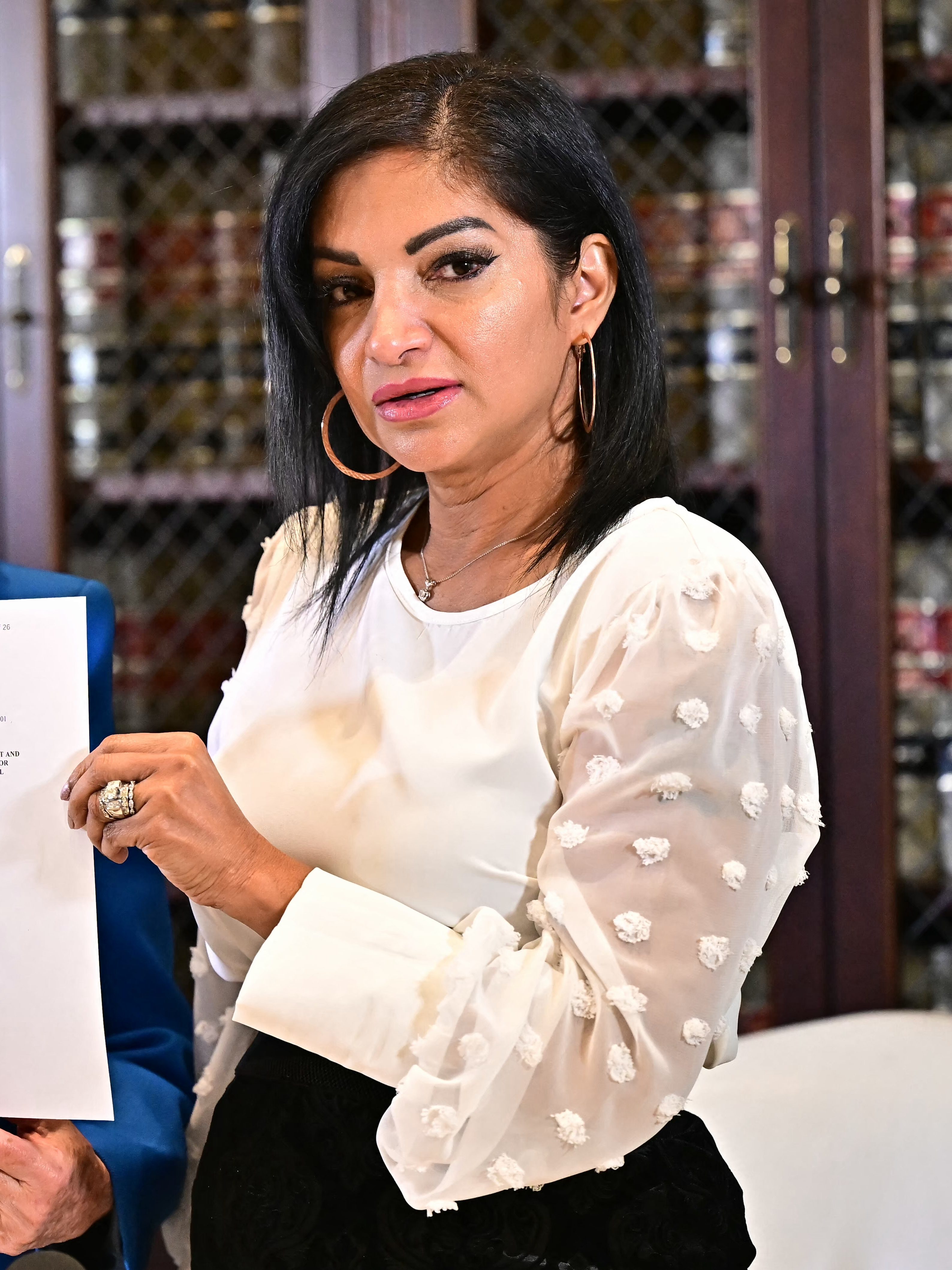 Thalia Graves, an alleged victim of Rap mogul Sean Diddy Combs, hold a copy of a criminal complaint during a press conference in Los Angeles on September 24, 2024. Graves is suing Combs for rape. Combs is imprisoned pending trial on racketeering and sex trafficking charges, after Judge Andrew Carter upheld a ruling on Septemebr 18, that the bail package proposed by his defense team was insufficient given his history of violence and substance abuse, and the possibility of witness tampering. (Photo by Frederic J. Brown / AFP) (Photo by FREDERIC J. BROWN/AFP via Getty Images)