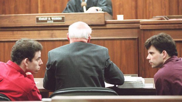 LOS ANGELES, UNITED STATES:  Erik (L) and Lyle (R) Menendez converse in the courtroom during a hearing in Los Angeles, in this 02 February 1995 file picture. They are accused of murdering their parents in 1989. (Photo credit should read KIM KULISH/AFP via Getty Images)