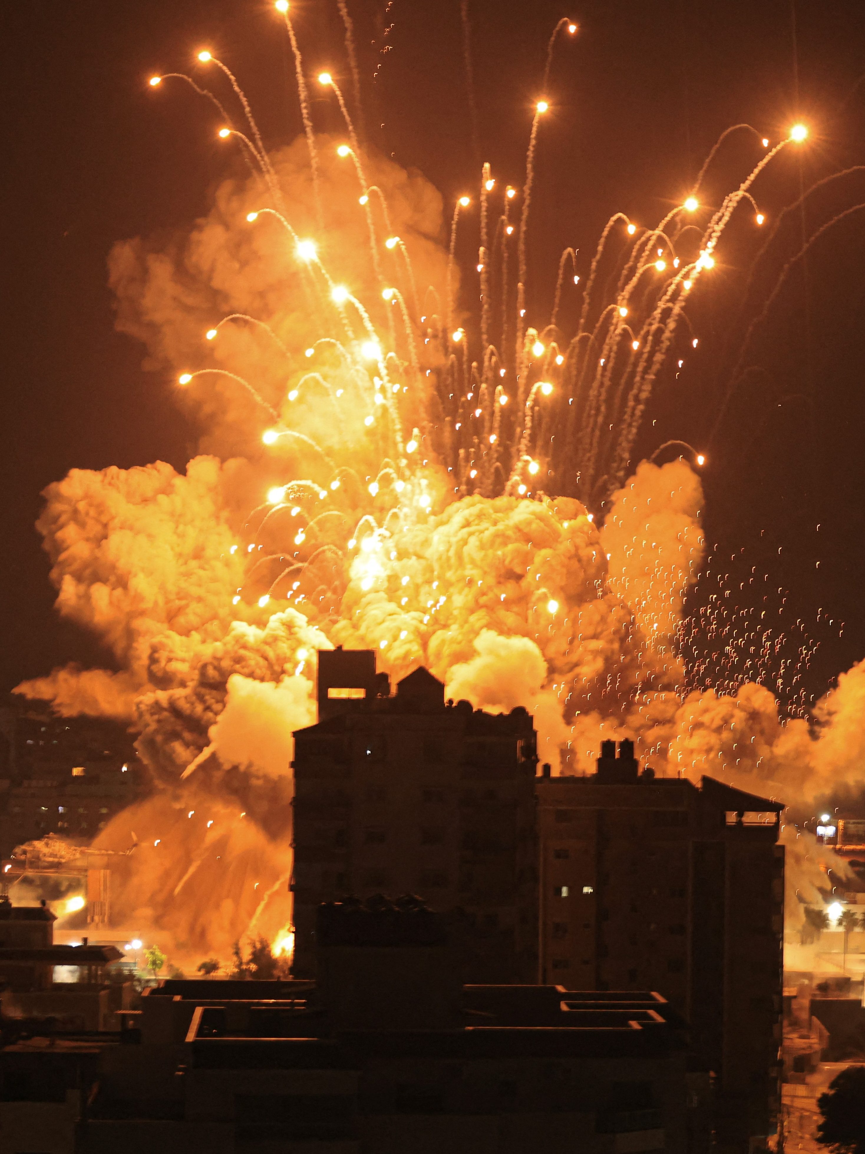 A missile explodes in Gaza City during an Israeli air strike on October 8, 2023. srael, reeling from the deadliest attack on its territory in half a century, formally declared war on Hamas Sunday as the conflict's death toll surged close to 1,000 after the Palestinian militant group launched a massive surprise assault from Gaza. (Photo by MAHMUD HAMS / AFP) (Photo by MAHMUD HAMS/AFP via Getty Images)