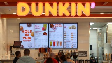 NEWARK, NJ - MAY 17: People line up at a Dunkin' store inside Terminal A at Newark Liberty International Airport on May 17, 2024, in Newark, New Jersey. (Photo by Gary Hershorn/Getty Images)