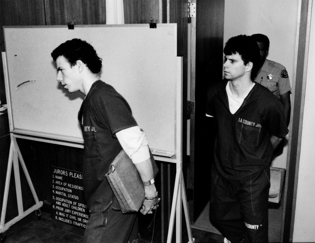 Erik Menendez, left, and his brother Lyle, wearing jail outfits, are led into courtroom. June 15, 1990. (Larry Davis / Los Angeles Times via Getty Images)