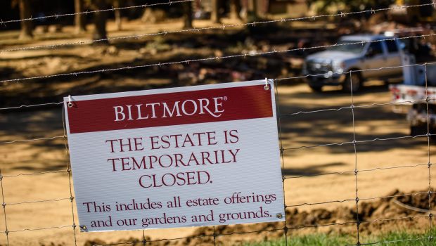 ASHEVILLE, NC - OCTOBER 9: A sign is posted outside the entrance of the Biltmore Estate in Asheville, NC on October 9, 2024. While the estate itself did not become damaged, its entrance and a popular shopping center across the street, Biltmore Village, sustained severe damage.