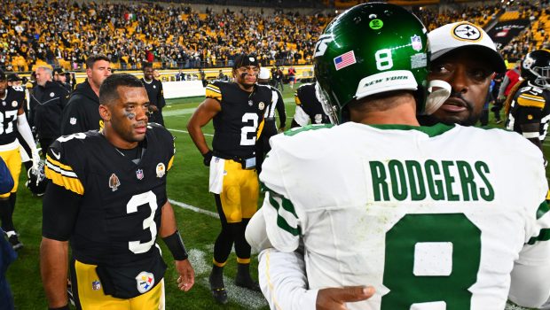 PITTSBURGH, PENNSYLVANIA - OCTOBER 20: Russell Wilson #3 and Justin Fields #2 of the Pittsburgh Steelers look on as head coach Mike Tomlin of the Pittsburgh Steelers and Aaron Rodgers #8 of the New York Jets embrace after the game at Acrisure Stadium on October 20, 2024 in Pittsburgh, Pennsylvania. (Photo by Joe Sargent/Getty Images)