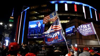 Donald Trump supporters wait outside Madison Square Garden where former US President and Republican presidential candidate Donald Trump holds a campaign rally in New York, October 27, 2024. (Photo by Leonardo Munoz / AFP) (Photo by LEONARDO MUNOZ/AFP via Getty Images)