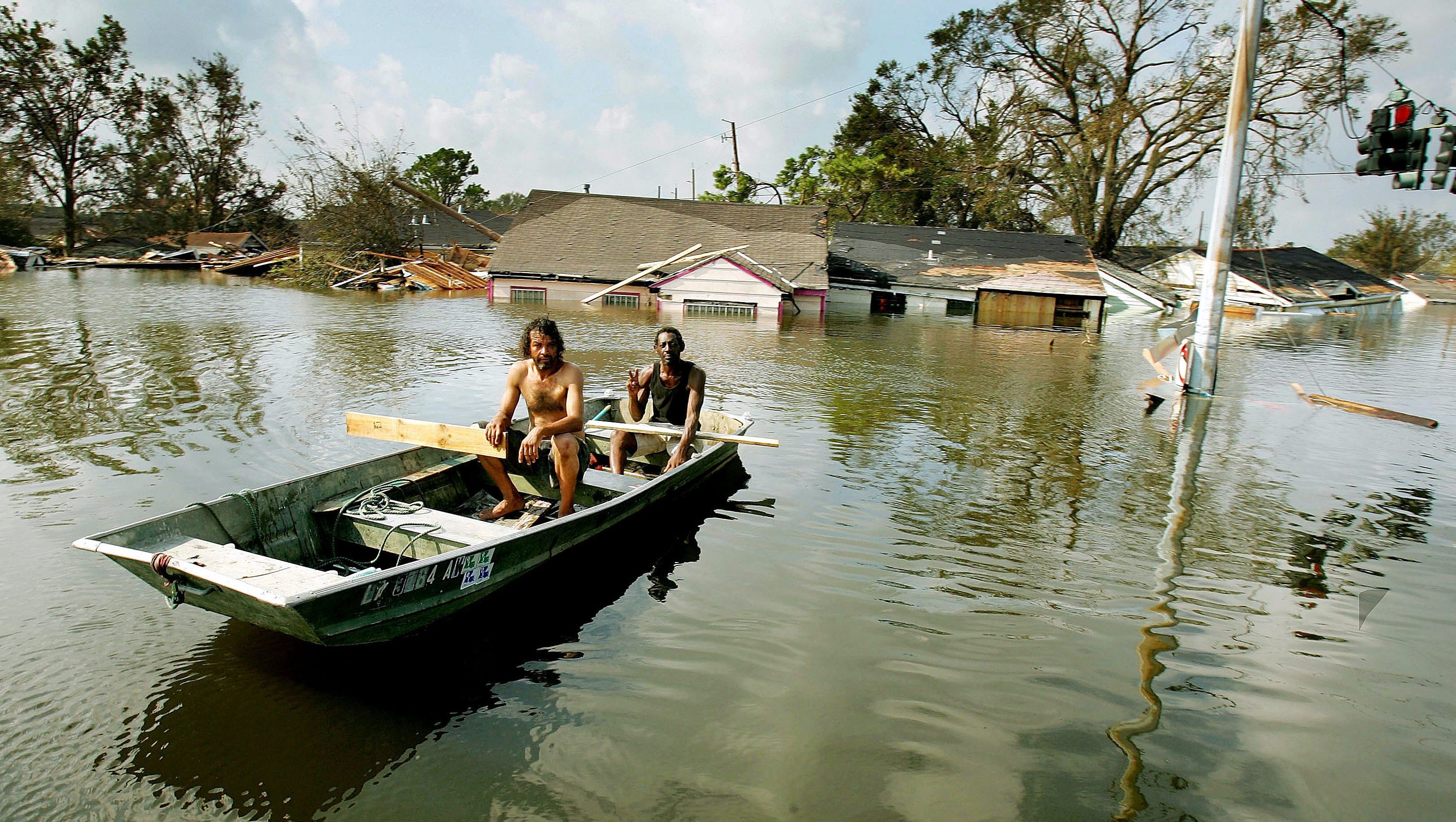 NEW ORLEANS - AUGUST 31:  Two men paddle in high water in the Ninth Ward after Hurricane Katrina devastated the area August 31, 2005 in New Orleans, Louisiana. Devastation is widespread throughout the city with water approximately 12 feet high in some areas. Hundreds are feared dead and thousands were left homeless in Louisiana, Mississippi, Alabama and Florida by the storm.  (Photo by Mario Tama/Getty Images)