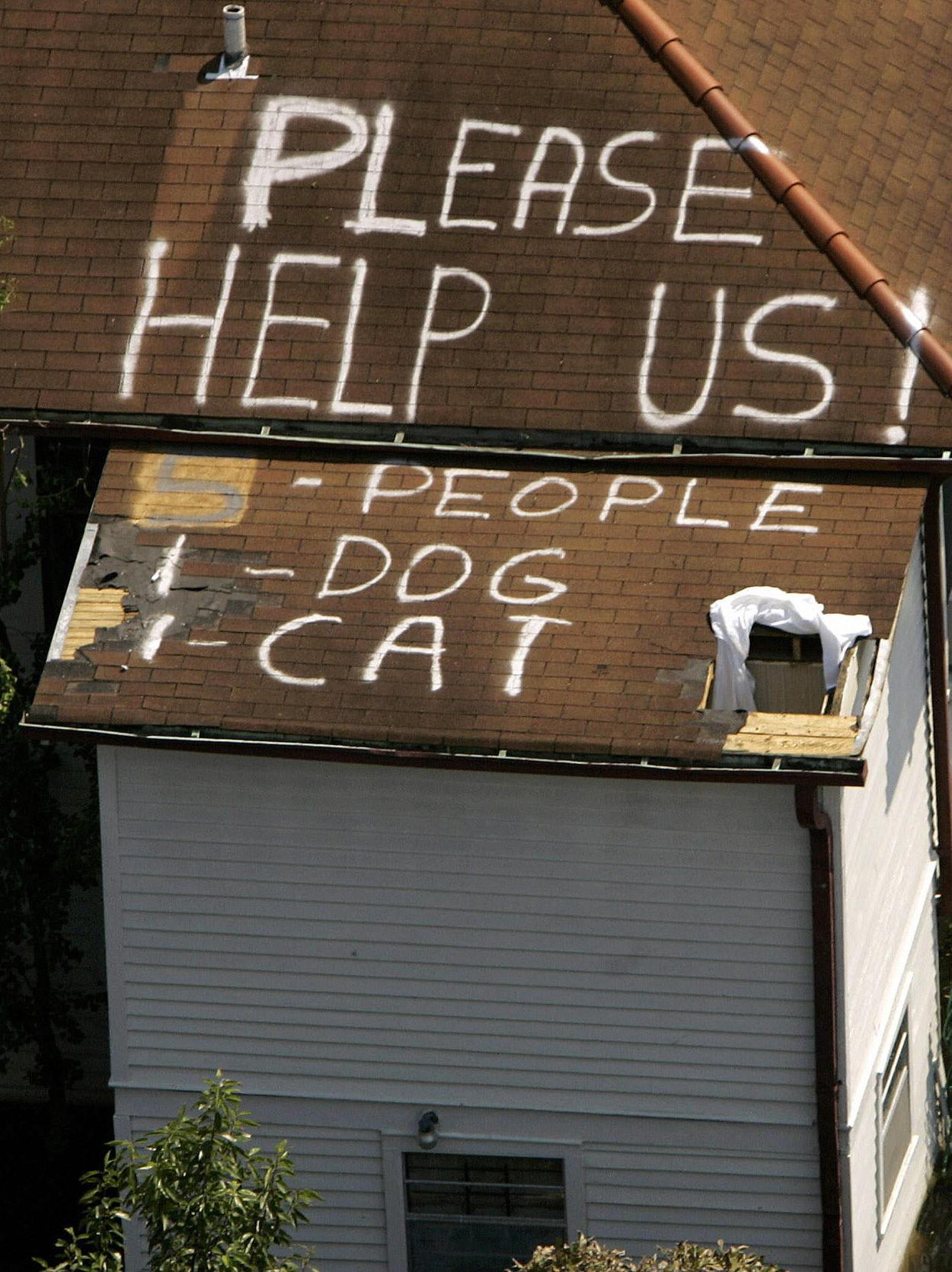 New Orleans, UNITED STATES:  A plea for help appears on the roof of a home flooded in the aftermath of Hurricane Katrina in New Orleans, Louisiana, 04 September 2005. New Orleans began counting its dead 04 September as US troops turned to the gruesome task of harvesting bloated corpses from the hurricane-torn city's flooded streets and homes.   AFP PHOTO/POOL/Robert GALBRAITH  (Photo credit should read ROBERT GALBRAITH/AFP via Getty Images)