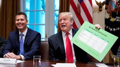 US President Donald Trump, with US Congressman Sean Duffy (L), holds a tariff table as he speaks in the Cabinet Room of the White House on January 24, 2019. - Trump spoke about the unfair trade practices at play in the world. (Photo by MANDEL NGAN / AFP) (Photo credit should read MANDEL NGAN/AFP via Getty Images)