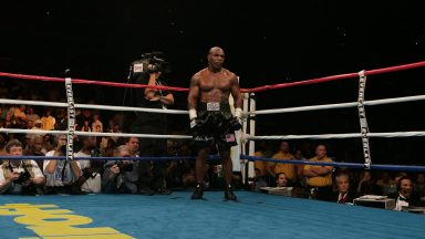 Former heavyweight champion Mike Tyson waits in the "neutral corner" after inflecting a ruled intentional head-butt against opponent Kevin McBride of Ireland, 11 June 2005 at the MCI Center in Washington, DC, in a non-title bout. McBride was declared winner when Tyson quit, sitting on his ring-corner-stool before the 7th round. Tyson announced his retirement after the fight. AFP PHOTO/Paul J. RICHARDS (Photo credit should read PAUL J. RICHARDS/AFP via Getty Images)