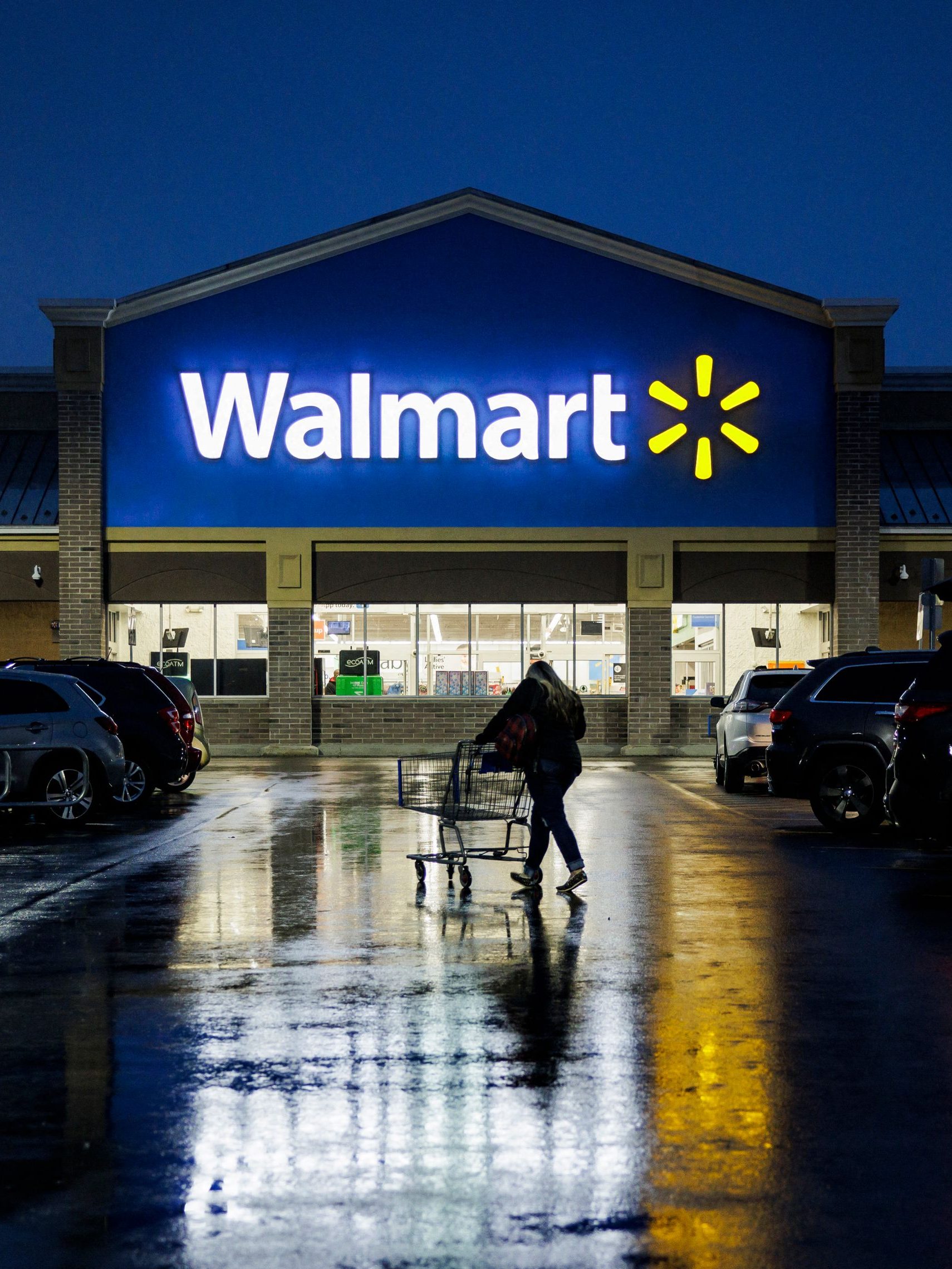 A shopper pushes a cart through the parking lot of a Walmart on the morning of Black Friday in Wilmington, Delaware, on November 25, 2022. - With inflation on the rise, retailers are expecting that many shoppers will be looking for especially good deals as discretionary spending falls. (Photo by Samuel Corum / AFP) (Photo by SAMUEL CORUM/AFP via Getty Images)