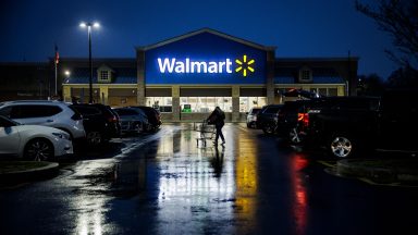 A shopper pushes a cart through the parking lot of a Walmart on the morning of Black Friday in Wilmington, Delaware, on November 25, 2022. - With inflation on the rise, retailers are expecting that many shoppers will be looking for especially good deals as discretionary spending falls. (Photo by Samuel Corum / AFP) (Photo by SAMUEL CORUM/AFP via Getty Images)