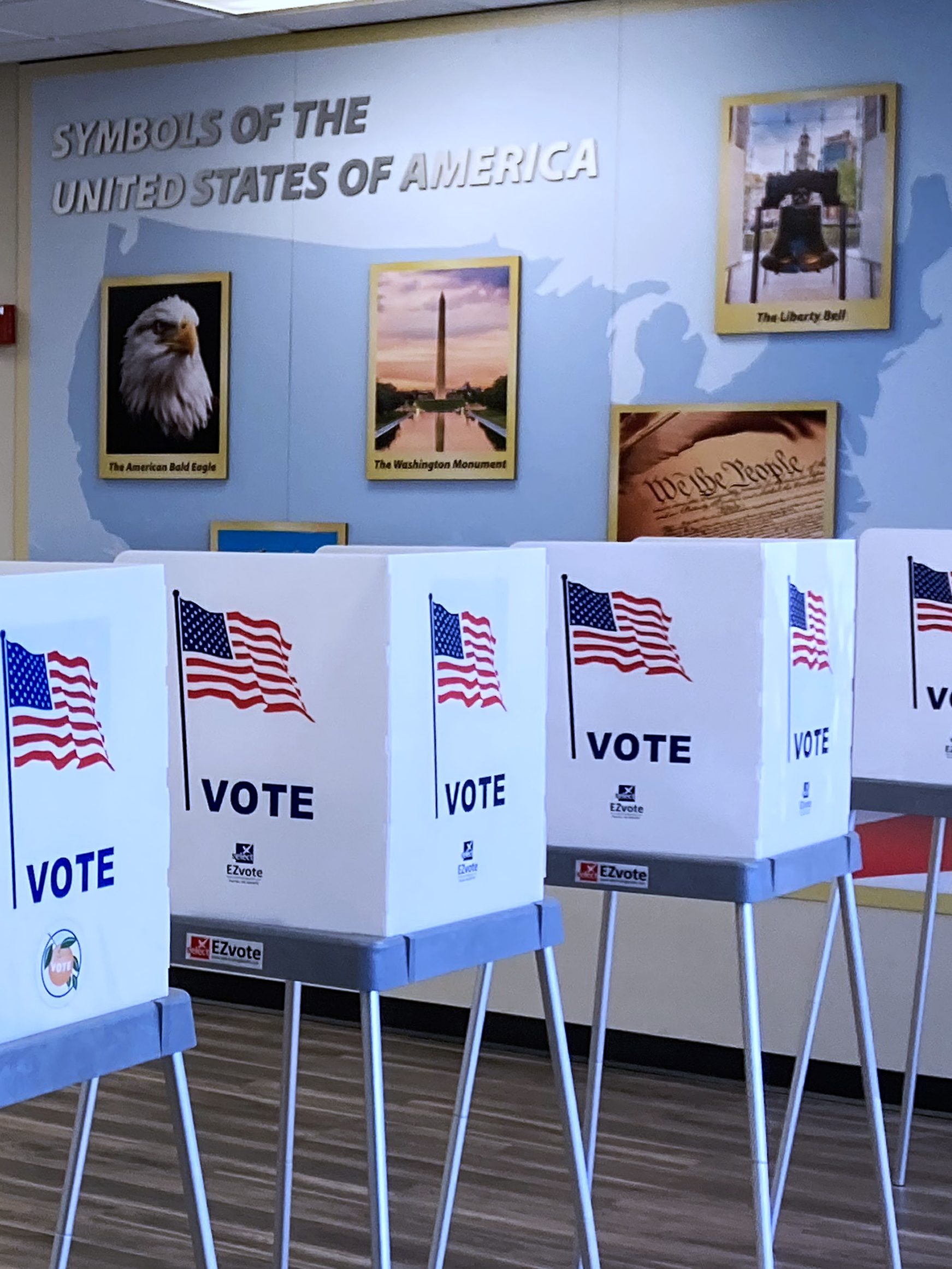 ORLANDO, FLORIDA, UNITED STATES - OCTOBER 17: Voting booths are seen near a display of symbols of the United States at the Orange County Supervisor of Elections office on October 17, 2024 in Orlando, Florida. About 2.4 million vote-by-mail ballots have been requested by Florida voters so far for the 2024 general election. (Photo by Paul Hennessy/Anadolu via Getty Images)