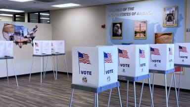 ORLANDO, FLORIDA, UNITED STATES - OCTOBER 17: Voting booths are seen near a display of symbols of the United States at the Orange County Supervisor of Elections office on October 17, 2024 in Orlando, Florida. About 2.4 million vote-by-mail ballots have been requested by Florida voters so far for the 2024 general election. (Photo by Paul Hennessy/Anadolu via Getty Images)