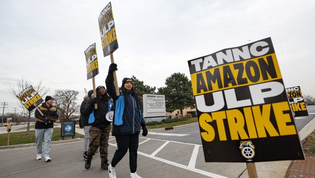 Amazon delivery drivers walk the picket line outside Amazon delivery station as they went on strike in Skokie, Illinois on December 19 2024. Thousands of workers at Amazon facilities across the United States went on strike Thursday, the Teamsters Union said, halting work at the height of the busy holiday gift-giving season. (Photo by KAMIL KRZACZYNSKI / AFP)