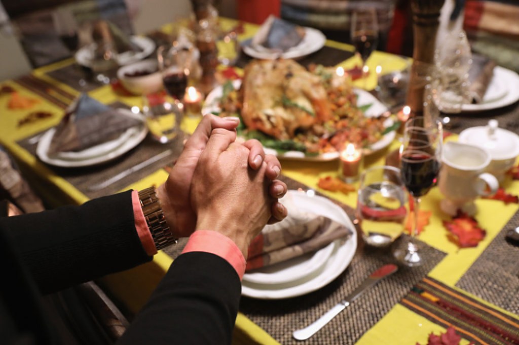 STAMFORD, CT - NOVEMBER 24: People from Central America and their families pray before eating Thanksgiving dinner on November 24, 2016 in Stamford, Connecticut. Family and friends, some of them US citizens, some with work visas and illegal immigrants gathered in the house to celebrate the American holiday with Turkish and Latin American dishes. They said they were affected by the results of the election of the American president Donald Trump, some said their children who were born in America are afraid that their parents may be deported when Trump enters the country. (Photo by John Moore/Getty Images)