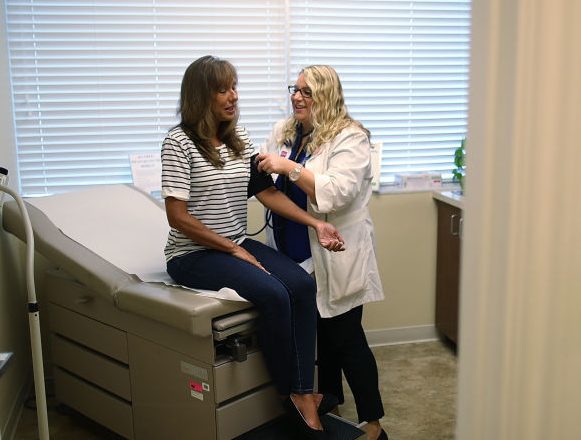 WELLINGTON, FL - JULY 13: Ginger Rae has her blood pressure checked by registered nurse Rachel Eisenberg during a checkup at a Planned Parenthood clinic on July 13, 2017 in Wellington, Florida. The United States Senate has released its health reform bill on Capitol Hill; The plan includes cutting funding to Planned Parenthood, the nation's largest provider of women's health care, for one year. Planned Parenthood Federation of America President Cecile Richards responded to the new bill by saying that ÒWith the latest version of Trumpcare, Americans will pay more and get less, but women will pay the highest price. Cutting Medicaid, reducing prenatal care, and shutting millions out of Planned Parenthood's preventive care would lead to undiagnosed cancers and more unplanned pregnancies. And it puts mothers and their children at risk. Now is the time for anyone who cares about women's health and access to affordable health care to speak up and join the fight.Ó (Photo by Joe Raedle/Getty Images)