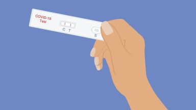 Hand Holding COVID-19 Rapid Test With Positive Test Result.