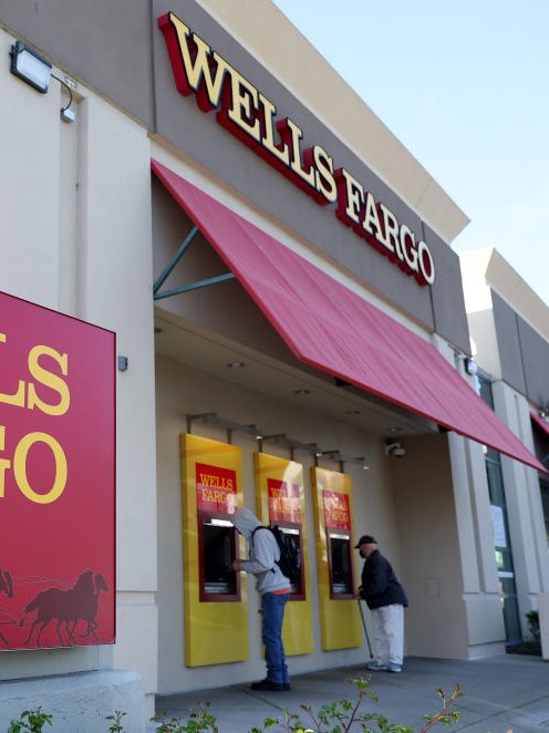 SAN BRUNO, CALIFORNIA - APRIL 14: Customers use ATMs at a Wells Fargo Bank on April 14, 2023 in San Bruno, California. Wells Fargo reported better-than-expected first quarter earnings of $5 billion, a 32 percent increase from earnings of $3.8 billion one year ago. (Photo by Justin Sullivan/Getty Images)