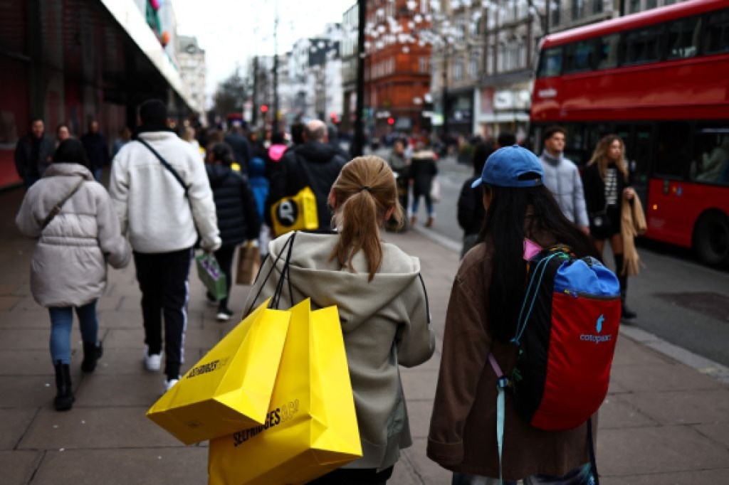 Shoppers carry their shopping bags along Oxford Street during the Boxing Day sales in London on December 26 2023 Photo by HENRY NICHOLLS AFP Photo by HENRY NICHOLLSAFP via Getty Images