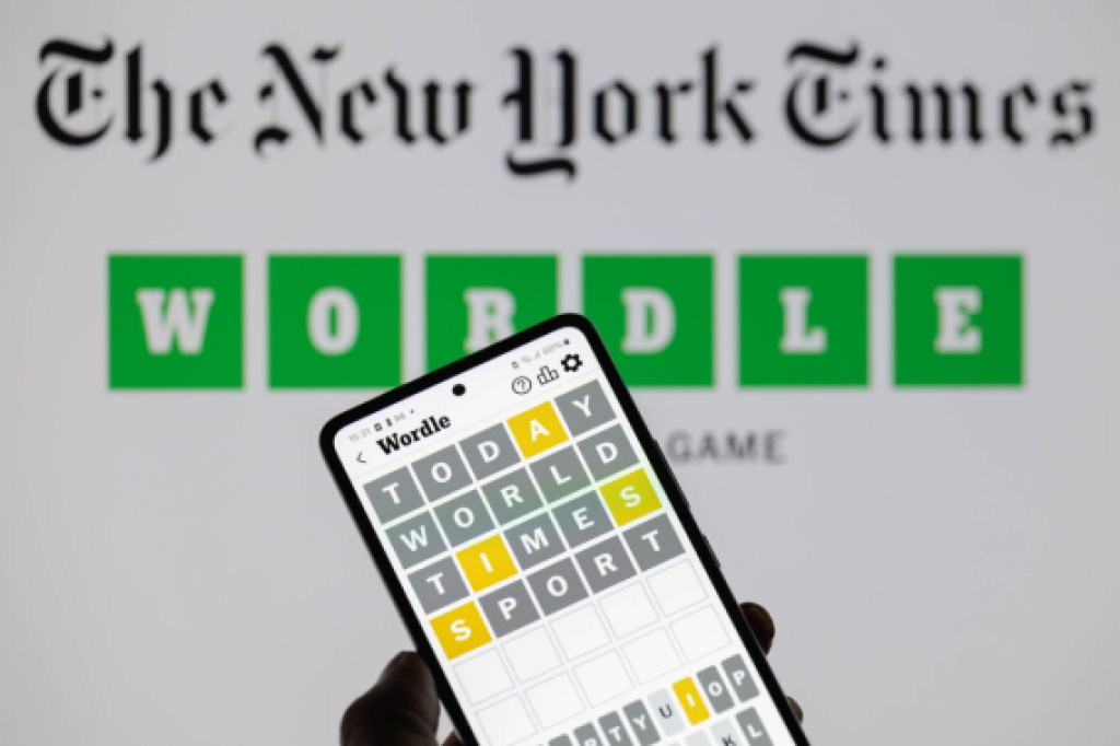 The Wordle app is being displayed on a smartphone with The New York Times visible in the background in this photo illustration in Brussels Belgium on June 1 2024 Photo by Jonathan RaaNurPhoto via Getty Images