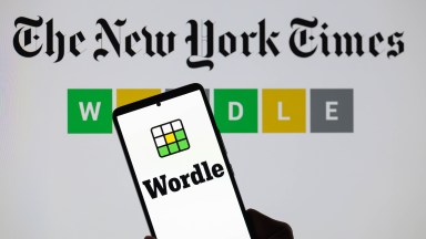 The Wordle logo is being displayed on a smartphone with The New York Times visible in the background in this photo illustration in Brussels, Belgium, on June 1, 2024. (Photo by Jonathan Raa/NurPhoto)