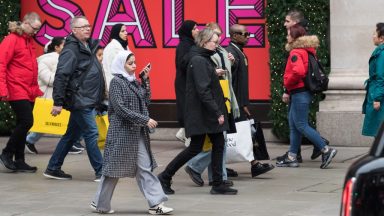  Shoppers walk outside Selfridge's store in Oxford Street during Boxing Day sales in London, United Kingdom on December 26, 2024. The second day of Christmas holidays, Boxing Day sees retailers offer large discounts which attract customers who this year are predicted to spend £3.73billion on the day itself on the high street and online. (Photo by Wiktor Szymanowicz/Anadolu via Getty Images)