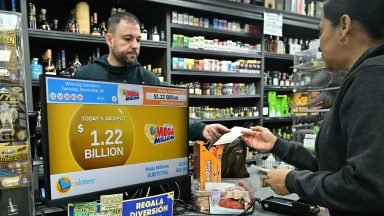 A person purchases their Mega Millions lottery ticket from a liquor store where winning tickets have been sold on December 27, 2024 in Hawthorne, California. The ninth-largest lottery jackpot in US history worth $1.15 billion will be drawn tonight in the Mega Millions drawing, after no tickets with all six numbers have been sold in 30 consecutive drawings. (Photo by Frederic J. BROWN / AFP)