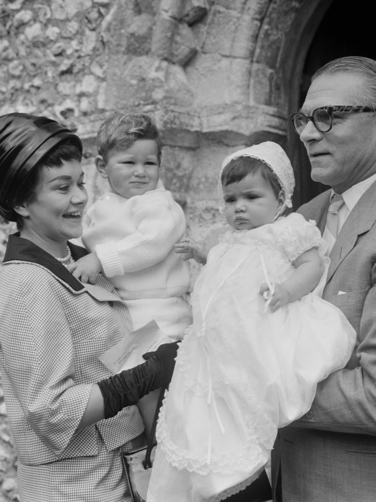 English actors Joan Plowright, holding son Richard, and Laurence Olivier (1907-1989) pictured attending the christening of their daughter Tamsin at a church in England on 15th July 1963. (Photo by Stanley Sherman/Express/Hulton Archive/Getty Images)