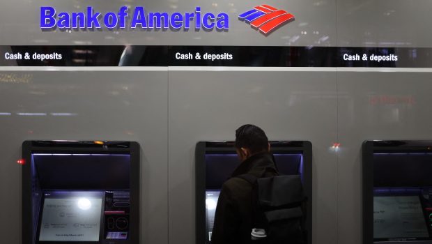 A person uses an ATM at a Bank of America in New York City on November 19, 2024. (Photo by CHARLY TRIBALLEAU / AFP)