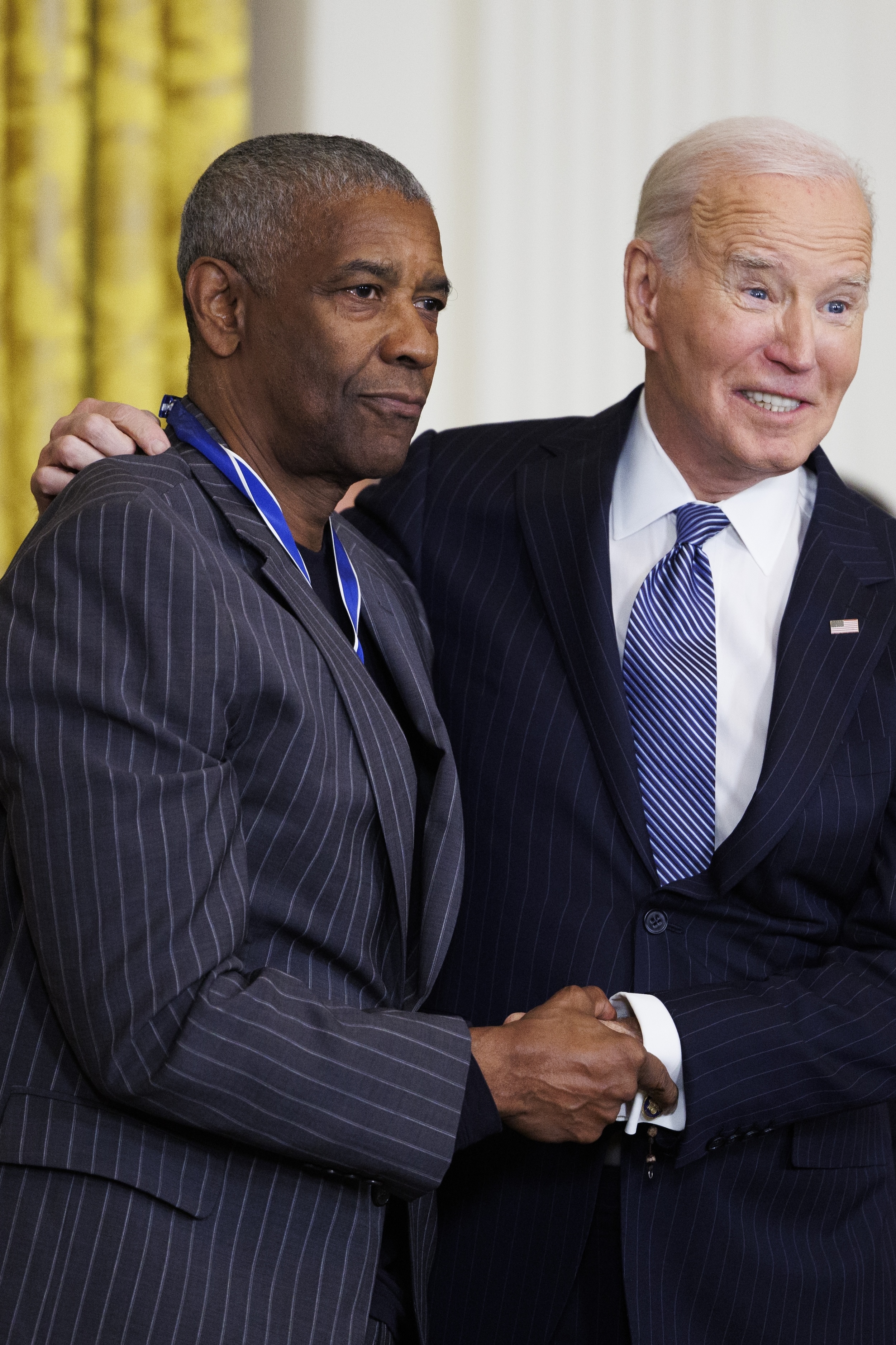 WASHINGTON, DC - JANUARY 4: Actor Denzel Washington greets U.S. President Joe Biden after being awarded the Presidential Medal of Freedom in the East Room of the White House on January 4, 2025 in Washington, DC. President Biden is awarding 19 recipients with the nation's highest civilian honor. President Biden is awarding 19 recipients with the nation's highest civilian honor. (Photo by Tom Brenner/Getty Images)