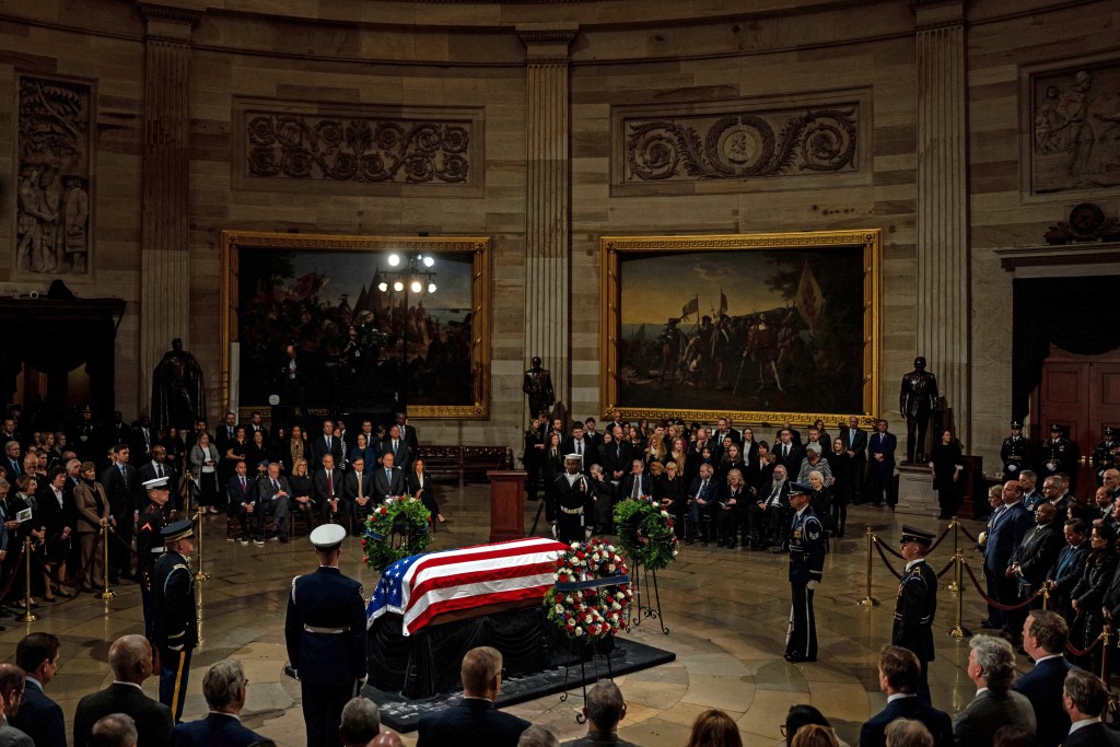 A military guard of honor stands next to the flag-draped casket of former US President Jimmy Carter during the Lying in State Ceremony at the US Capitol Rotunda in Washington, DC on January 7, 2025. Carter, the 39th President of the United States, died at the age of 100 on December 29, 2024 at his home in Plains, Georgia. (Photo by Kent NISHIMURA / POOL / AFP)