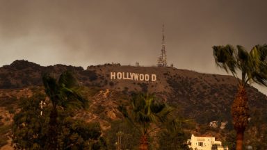 HOLLYWOOD, CA - JANUARY 08: The Hollywood Sign is seen with smoke from multiple wildfires on January 08, 2025 in Hollywood, California.  (Photo by AaronP/Bauer-Griffin/GC Images)