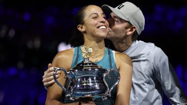 MELBOURNE, AUSTRALIA - JANUARY 25: Madison Keys of the United States is kissed by her coach and husband Bjorn Fratangelo after the Women's Singles Trophy Presentation following the Women's Singles Final against Aryna Sabalenka during day 14 of the 2025 Australian Open at Melbourne Park on January 25, 2025 in Melbourne, Australia. (Photo by Cameron Spencer/Getty Images)