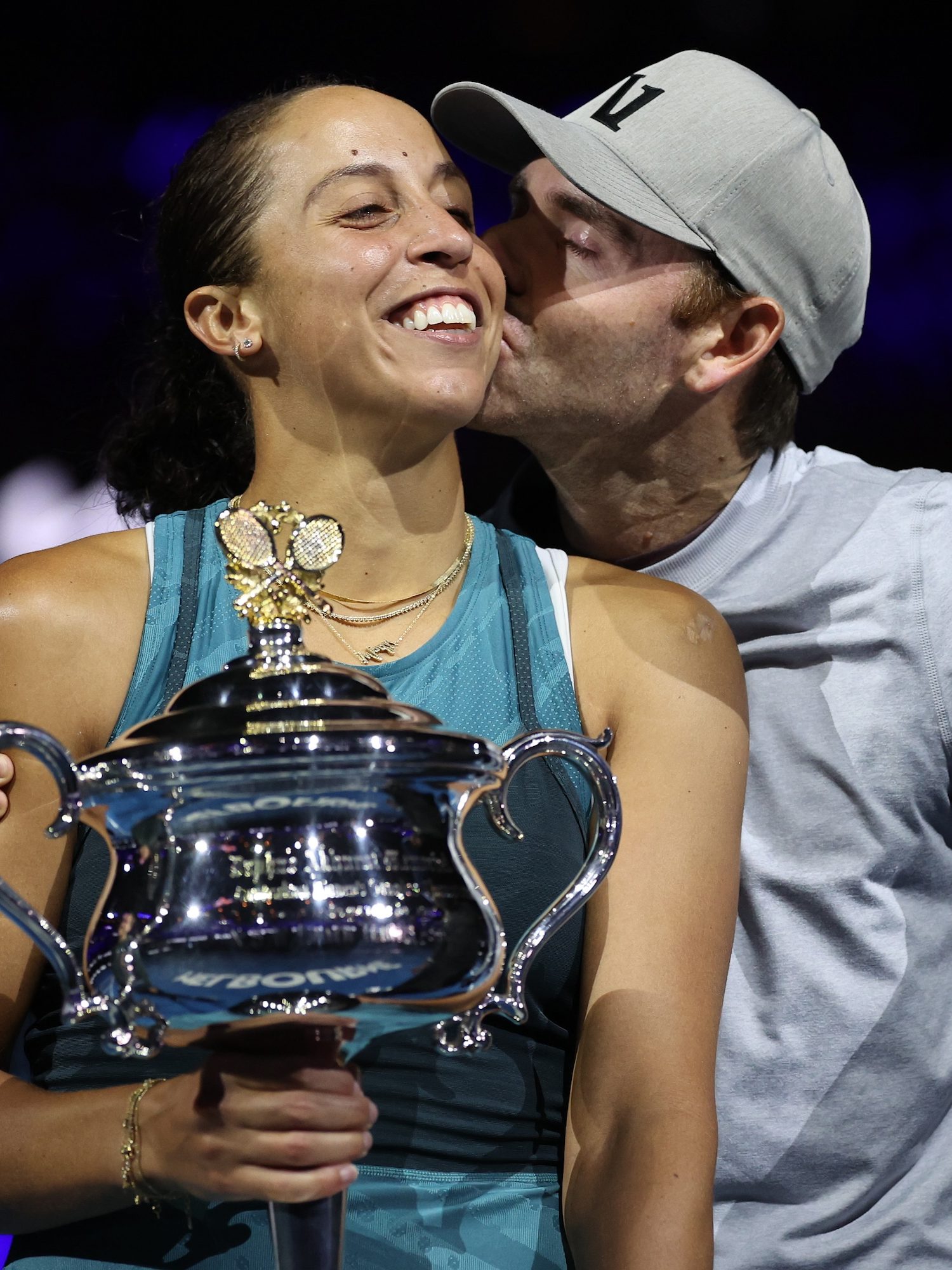 MELBOURNE, AUSTRALIA - JANUARY 25: Madison Keys of the United States is kissed by her coach and husband Bjorn Fratangelo after the Women's Singles Trophy Presentation following the Women's Singles Final against Aryna Sabalenka during day 14 of the 2025 Australian Open at Melbourne Park on January 25, 2025 in Melbourne, Australia. (Photo by Cameron Spencer/Getty Images)
