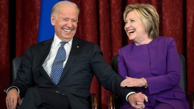 US Vice President Joe R. Biden (L) and former Secretary of State Hillary Clinton laugh during a portrait unveiling for outgoing Senate Minority Leader Senator Harry Reid (D-NV) on Capitol Hill December 8, 2016 in Washington, DC. / AFP / Brendan Smialowski        (Photo credit should read BRENDAN SMIALOWSKI/AFP via Getty Images)