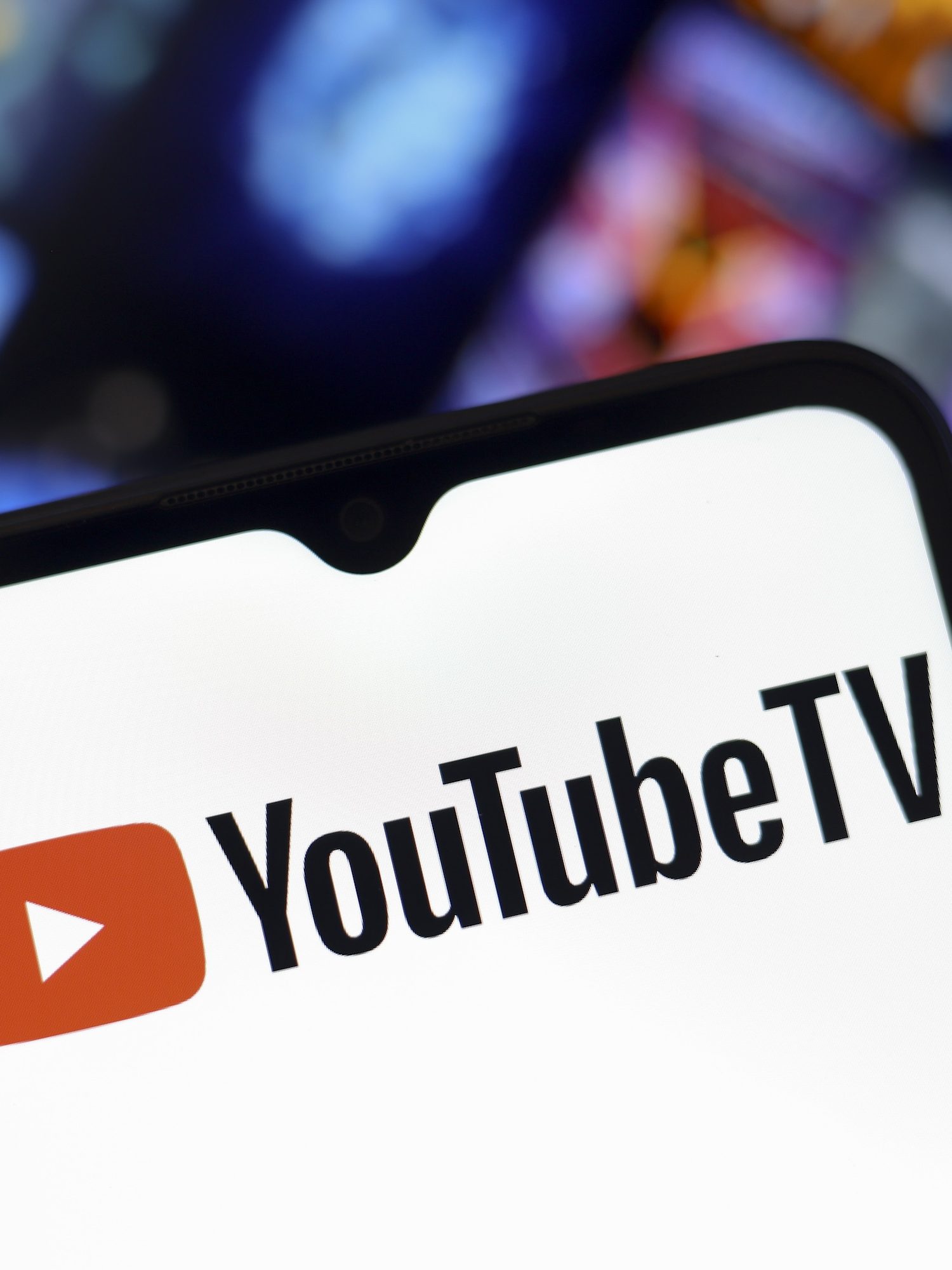 The YouTube TV logo appears on the screen of a smartphone and in the background on the computer screen in Reno, United States, on December 15, 2024. (Photo by Jaque Silva/NurPhoto)