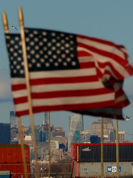 BAYONNE, NJ - FEBRUARY 1: Shipping containers stand on a dock at the Port Jersey container terminal in front of the Statue of Liberty and the Empire State Building in New York City on February 1, 2025, as seen from Bayonne, New Jersey.  (Photo by Gary Hershorn/Getty Images)