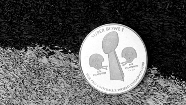 HOUSTON, TX - JANUARY 13, 1974: The commemorative coin used for the coin toss at Super Bowl I lies on the field prior to Super Bowl VIII on January 13, 1974 between the Miami Dolphins and the Minnesota Vikings at Rice Stadium in Houston, Texas.  The Dolphins beat the Vikings, 24-7 to win the professional football World Championship.19740113-FR-1974 Kidwiler Collection/Diamond Images