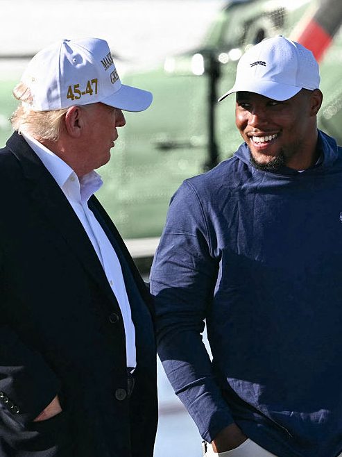 TOPSHOT - US President Donald Trump (L) walks with Philadelphia Eagles running back Saquon Barkley before boarding Air Force One  Morristown Municipal Airport in Morristown, New Jersey, on April 27, 2025. Trump is returning to Washington, DC, from his residence in Bedminster, New Jersey, after traveling to Rome for the funeral of Pope Francis. (Photo by Mandel NGAN / AFP) (Photo by MANDEL NGAN/AFP via Getty Images)
